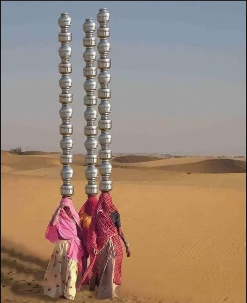 Arabic women in the desert with multiple vases on their head